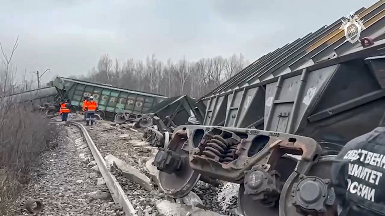 In this handout photo taken from video released by Investigative Committee of Russia on Saturday, Nov. 11, 2023, Russian Railways Company employees work at the side of derailed train carriages carrying cargo in Ryazan region, Russia. Freight cars carrying cargo in Russia's Ryazan region were derailed Saturday morning by an improvised explosive device, Russian law enforcement said. Nineteen carriages traveling from the town of Rybnoye were thrown from the tracks and 15 were damaged, investigators wrote in a statement on social media. (Investigative Committee of Russia via AP)