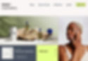 Homepage of a cosmetics site called Radu, with an image of products displayed on a beige rock, and a woman applying skincare.